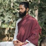 Swami Hari (Swami Chaittanya Hari), founder of Yoga Nisarga, seated in meditation outdoors