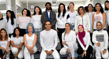 Yoga teacher training students and teachers in white kurtas at a Yoga Nisarga graduation